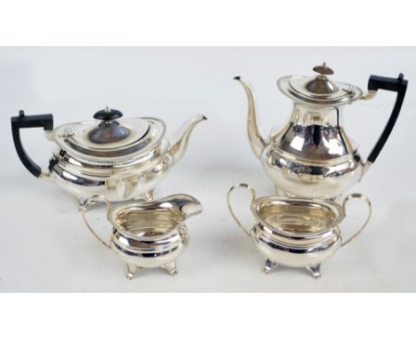 ELKINGTON & CO; a George V hallmarked silver four piece tea set of bellied form with gadrooned rim, each piece raised on four