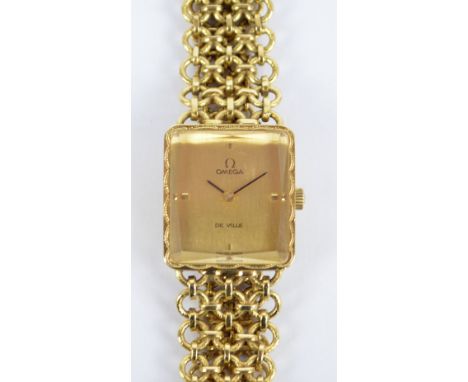 OMEGA; a 9ct yellow gold De Ville lady's wristwatch, the rectangular dial set with four baton numerals, with engraved decorat