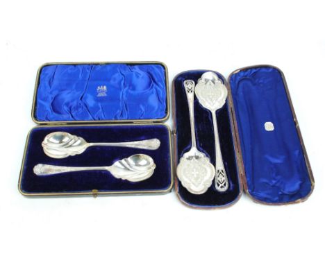 JAMES DIXON & SONS; a boxed pair of Edward VII hallmarked silver serving spoons with flat shaped bowls and pierced floral fin
