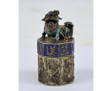 A Chinese white metal and enamel detailed hexagonal seal with archaic marks to the base, surmounted with a figure of a dog of