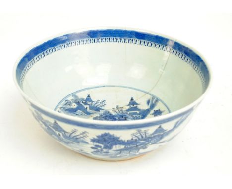 A late 18th/early 19th century Chinese circular punch bowl painted in underglaze blue with architectural river landscape to t