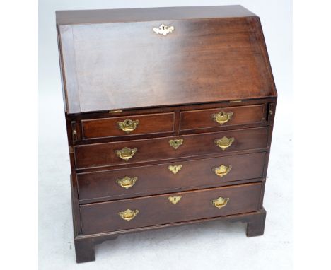 A George III mahogany bureau with two short and three long graduated drawers on bracket feet, width 89cm.