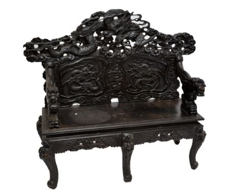 A c.1900 Chinese ebonised carved hardwood hall bench, elaborately decorated with a dragon amongst clouds to the domed back ab