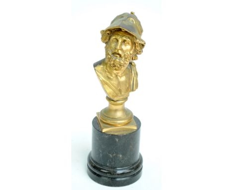 A late 19th century gilt metal bust depicting a Classical bearded gentleman wearing a helmet on socle plinth and polished bla