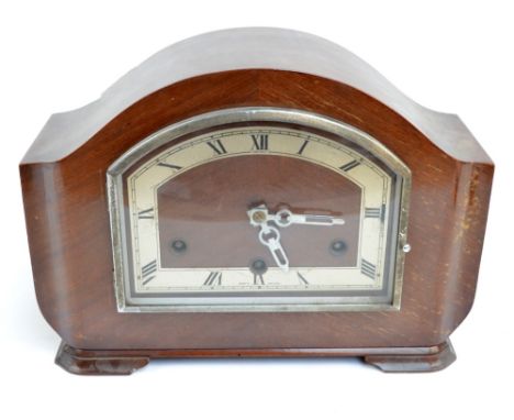 A 1930's Art Deco walnut mantel clock with shaped chapter ring set with Roman numerals, width 31cm.