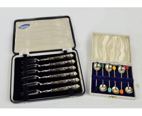 COOPER BROTHERS & SONS; a cased set of six Elizabeth II hallmarked silver coffee bean spoons with different coloured finials,