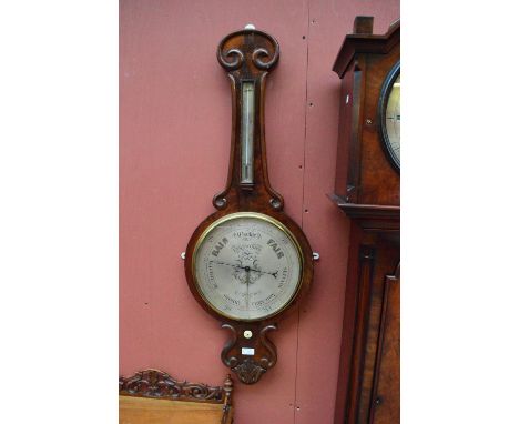 A large Victorian mahogany wheel barometer with unusual 12" silvered dial, signed Farnworth, Blackburn.   CONDITION REPORT:  