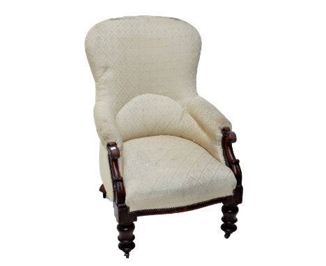 An early Victorian mahogany spoon back upholstered easy chair, raised on ring turned front legs.