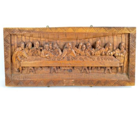 A large carved wooden panel depicting The Last Supper, set with a copper plaque inscribed 'Presented to Father John Osmand', 
