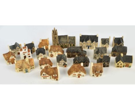 A collection of Philip Laureston small flat back ceramic period buildings including houses, pubs, church, etc, all stamped to