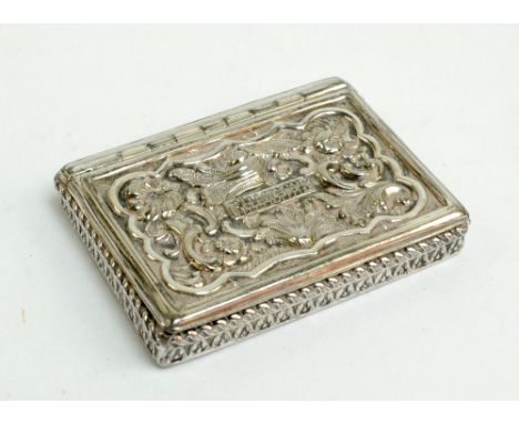 A unmarked Victorian white metal rectangular snuff box with repoussé decoration to the hinged lid and gilt washed interior, t