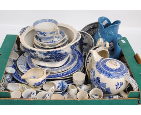 A large collection of blue and white ceramics including platters of various sizes, plates, teapot, jugs, egg cups, model clog