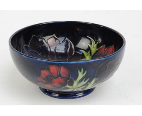 MOORCROFT; a modern "Anemone" pattern tube lined decorated bowl on dark blue ground, signed and impressed marks with arrow sy