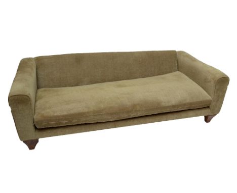 A large modern pale green upholstered three seater sofa.