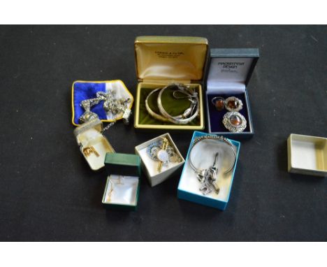 A small group of costume jewellery including two silver snap bangles, a pair of loop shaped drop earrings, a moss agate set b