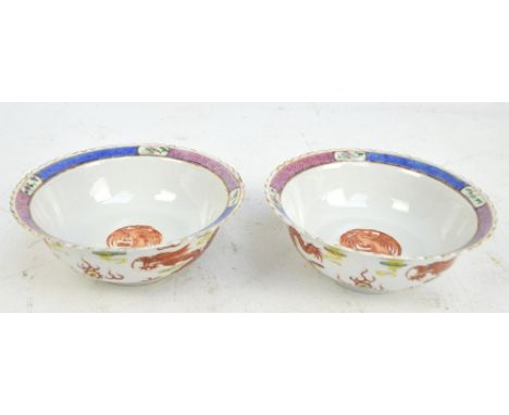 A pair of Chinese Republic Jiangxi Ciye Gongsi porcelain bowls, painted in iron red with roundel depicting a phoenix, with ge