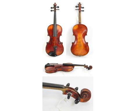A full size German violin, Stradivarius copy with label, the one-piece back 35.9cm, cased with a bow.