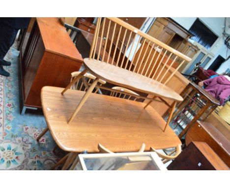 A blond oak Ercol dining table on trestle base, length approx 153cm with four stick back chairs with padded seats and a stick