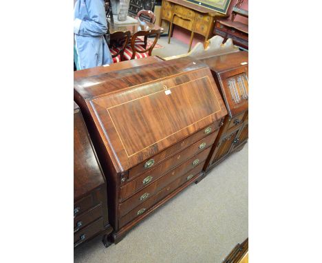 An early 19th century mahogany bureau, the fall front enclosing fitted interior of pigeon holes flanked by three small drawer