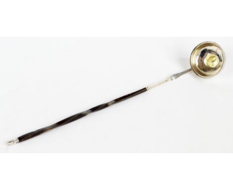 A Georgian white metal toddy ladle, the circular bowl set with George III coin, 1787, with twist baleen handle, length 34.5cm