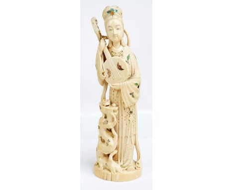 A good Japanese Meijii period carved ivory and Shibyama style inlaid okimono depicting a young woman playing a zhongruan with