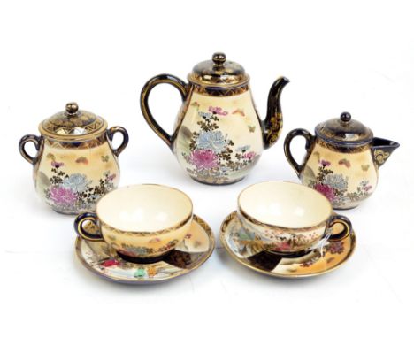 A Japanese Meiji period Satsuma tea set comprising a teapot, height 16.5cm, a cream jug, a sugar bowl with cover and a pair o