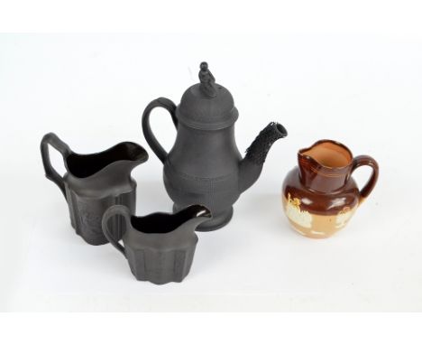 Two similar black basalt ceramic jugs, mould decorated with classical scenes and a similar baluster coffee pot with figural f