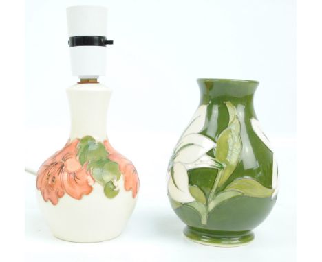 MOORCROFT; A "Hibiscus" pattern tube lined decorated bottle vase baluster lamp base on cream ground, height 19.5cm including 