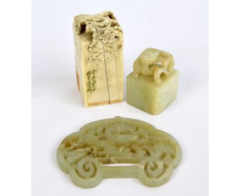 A Chinese carved ivory seal decorated with blossoming branches, signed to one face and bearing paper labels, height 6.25cm, a