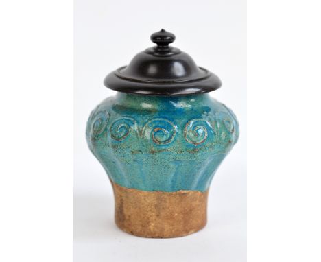 A Chinese late Ming Provincial ceramic baluster jar with turquoise glazed footed and mould scroll decorated upper body, unmar