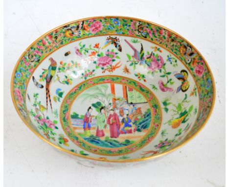 A 19th century Chinese Canton Famille Rose bowl centred with a group of figures and a horse in landscape within a bird, butte