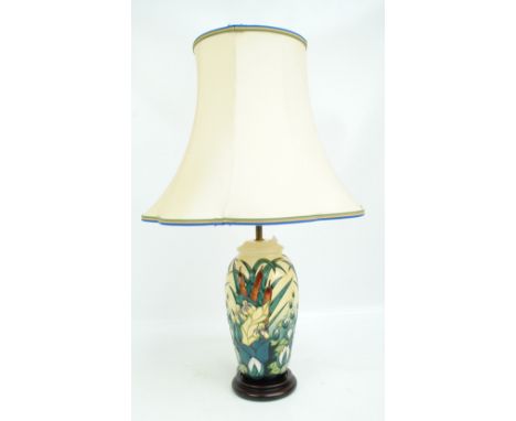 MOORCROFT; A "Lamia" pattern tube lined decorated baluster lamp base on yellow ground, on turned wooden attached stand, heigh