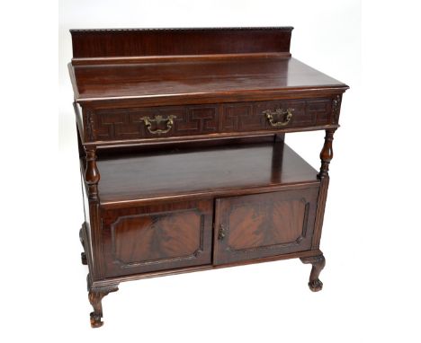 An early 20th century mahogany sideboard buffet with galleried back, two drawers with geometric key design, shelf above two h