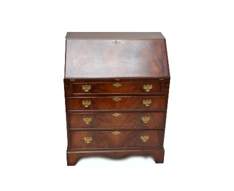 A reproduction mahogany bureau with fall front above four long drawers on bracket feet, width 76cm.