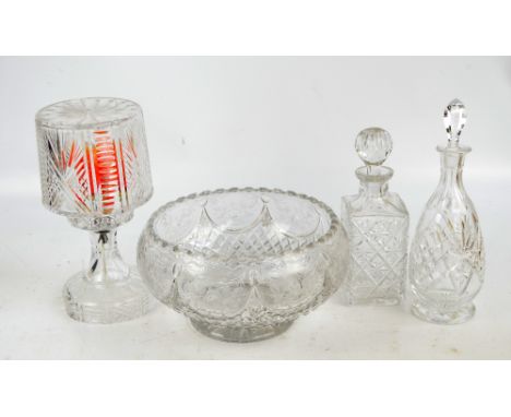 A large floral decorated cut glass punch bowl, two decanters and a cut glass lamp (4).