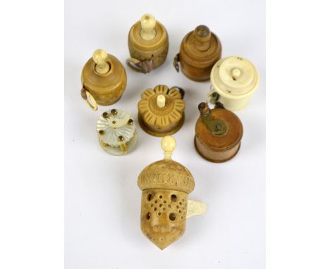 Eight late 19th century/early 20th century tape measures; four with vegetable ivory bodies, a mother of pearl example, an ivo