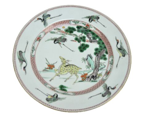 A Chinese Kangxi porcelain charger decorated with deer startled by crane in garden scene, rim with crane in flight decoration