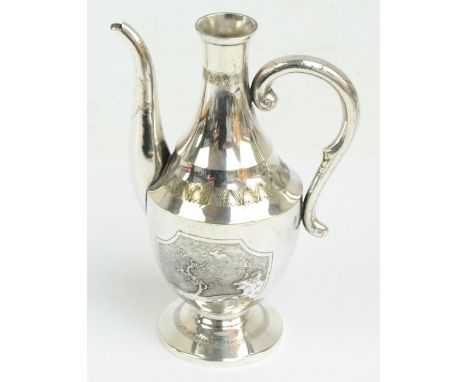 An early 20th century Chinese white metal baluster shaped ewer with loop handle embossed with architectural landscape on text