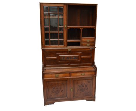 A Victorian mahogany display cabinet/writing desk with upper shelving, two small drawers, and hinged glazed door with bevelle