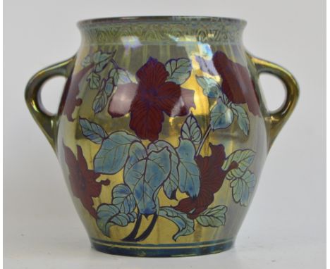 A Pilkington's Royal Lancastrian lustre twin handled vase by William S. Mycock, decorated with red flowers on a pale green lu