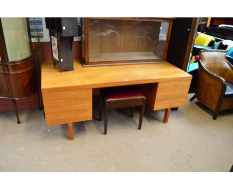 A Staverton furniture 1970's large teak desk with three doors to one side and a drawer and filing drawer to the other, raised