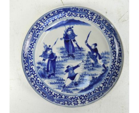 A late 18th/early 19th century Chinese porcelain plate, painted in underglaze blue with four warriors fighting, within a band