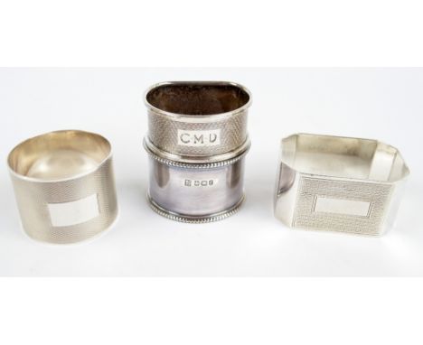 Four various hallmarked silver napkin rings including two engine turned decorated examples by WI Broadway & Co, one initialle