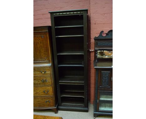 An Ercol narrow bookcase set with adjustable shelves.