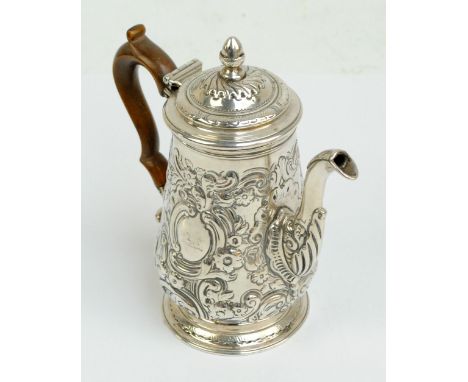 A Georgian white metal baluster coffee pot with later embossed floral and scroll decoration, with two opposing cartouches, th