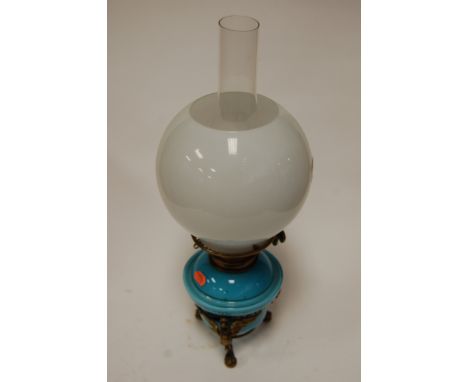 A Victorian oil lamp having opalescent globular glass shade, blue glass reservoir on a gilt brass base