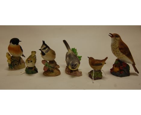 A collection of six Royal Worcester bird figures to include; Goldcrest, Wren, Thrush, Stonechat, Crested Tit, and Grey Wagtai