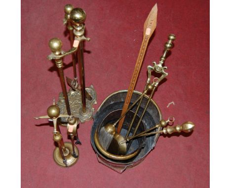 A collection of miscellaneous brasswares to include fire tools, helmet shaped coal scuttle, etc