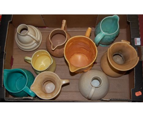 A collection of assorted early 20th century ceramic jugs to include Wade brown glazed example relief decorated with squirrels
