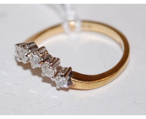 An 18ct gold five diamond set wishbone ring, size K-